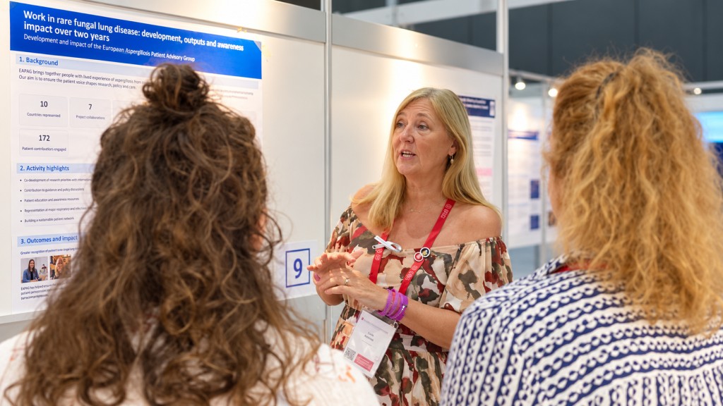 Lisa McNeil discussing the European Aspergillosis Patient Advisory Group poster with ERS delegates